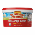Countryside Creamery Spreadable Butter with Canola Oil 15oz red tub with yellow and blue sky label and 90 calories per tbsp badge